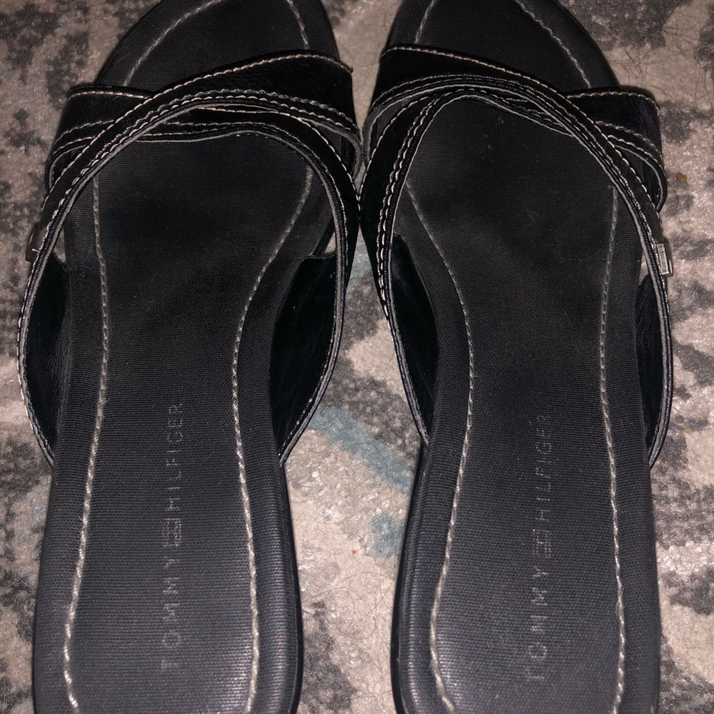 Black slip on wedged shoes.